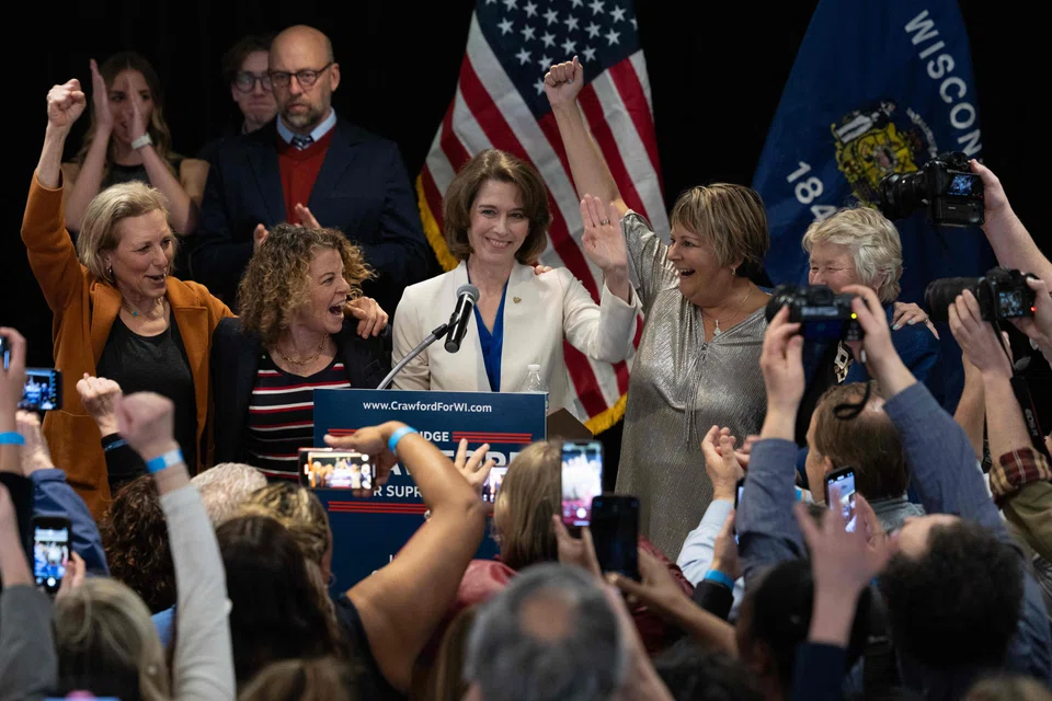Dane County Circuit Court Judge Susan Crawford, flanked by Wisconsin Supreme Court justices, accepts victory in her race for Wisconsin Supreme Court justice in Madison, Wisconsin, April 1, 2025.