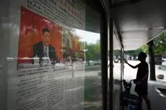 A newspaper featuring a story about the conclusion of the Third Plenum in Beijing. The meeting fell short of markets' expectations, with few concrete measures announced.