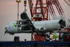 The main fuselage section of an ACT Airlines Boeing 747-400 cargo aircraft, leased by Emirates SkyCargo, is hoisted out of the water in Hong Kong on Oct 26.