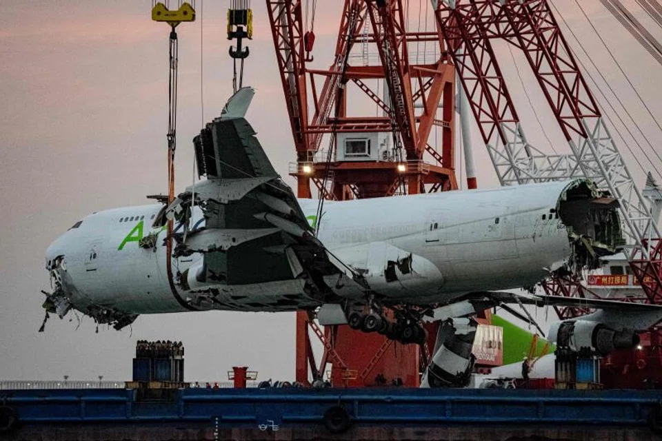 The main fuselage section of an ACT Airlines Boeing 747-400 cargo aircraft, leased by Emirates SkyCargo, is hoisted out of the water in Hong Kong on Oct 26.