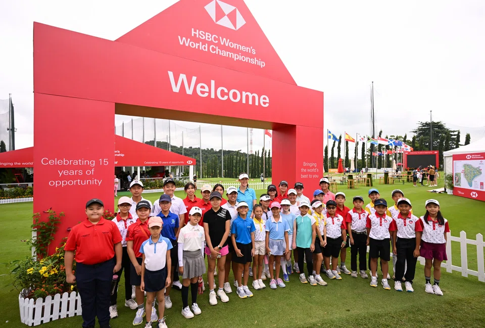 Former HSBC Women's World Championship winner Michelle Wie (back row, in blue) with a group of over 30 children from local golf clubs at Sentosa Golf Club.