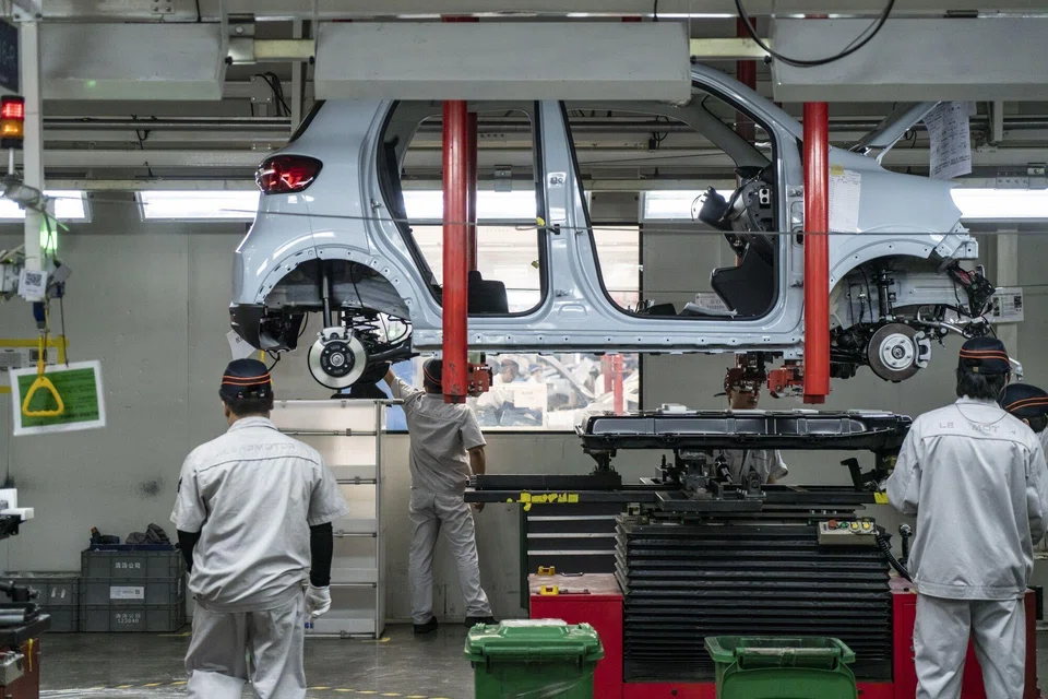 Workers on the assembly line at the Zhejiang Leapmotor Technology production facility in Jinhua, China, June 23, 2024. PHEV sales worldwide reached 1.4 million in July, of which 0.86 million were in China, where they were up 25 per cent year-on-year, Rho Motion said.