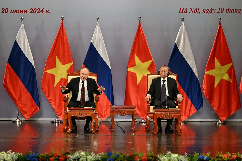 Russia's President Vladimir Putin and Vietnam's President To Lam in Hanoi. Putin says Moscow and Hanoi are interested in building what he calls a reliable security architecture in the Asia-Pacific region.