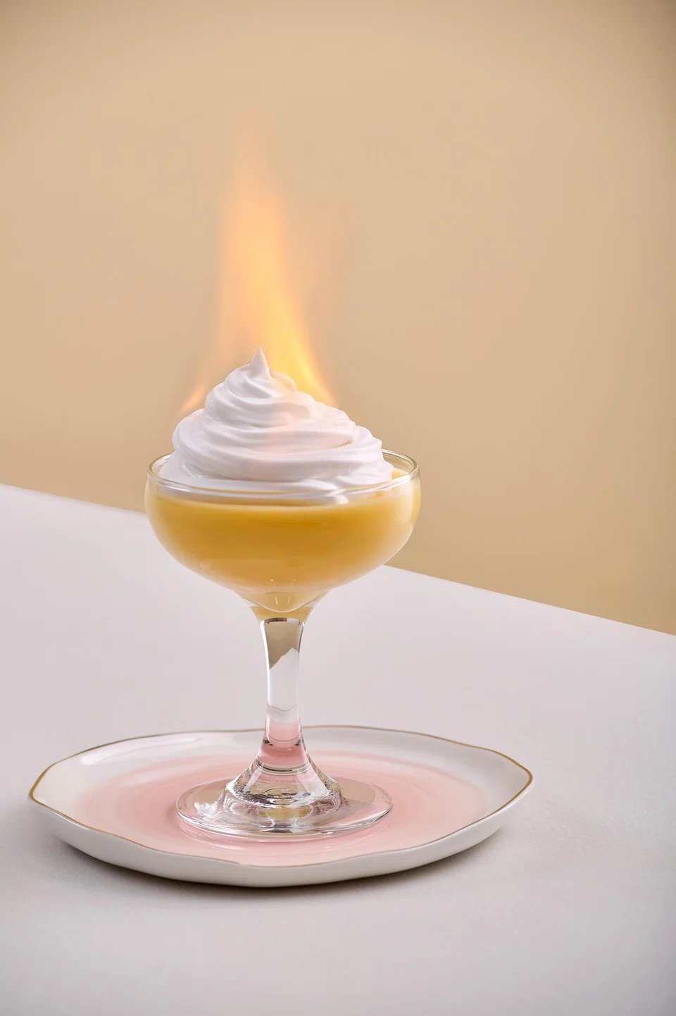 Mango pudding flambe is set alight at the table.