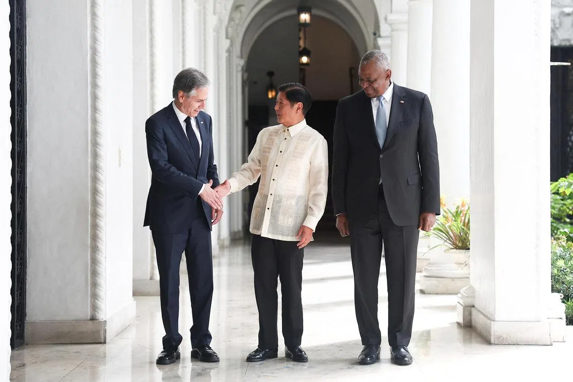 Philippine President Ferdinand Marcos Jr (centre), greets US Secretary of State Antony Blinken (left) and US Secretary of Defence Lloyd Austin (right) at the Malacanang presidential palace in Manila, Philippines, July 30, 2024. 