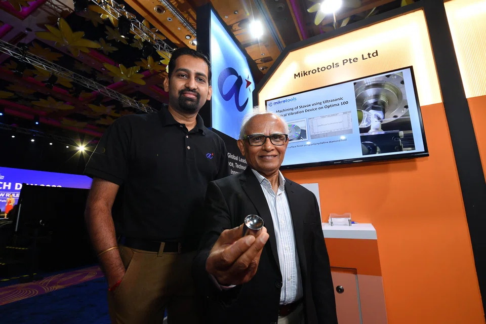 Dr Aravind Raghavendra, technical lead at ARTC (left) and Dr Mustafizur Rahman, director of Mikrotools, with the contact lens mould made using Mikrotools’ ultra-precision lathe machine. 
