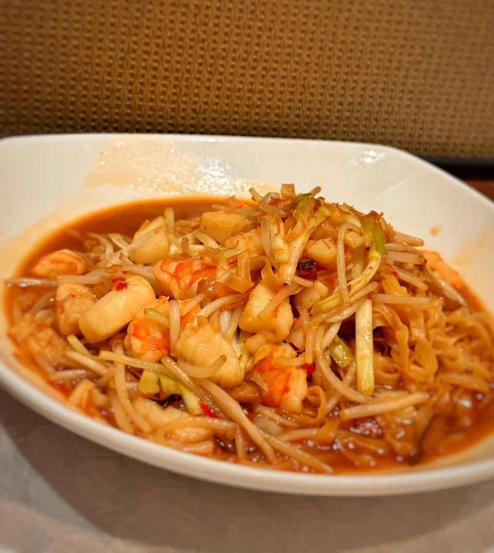 Mee pok is braised in a rich seafood stock with chunks of prawns.