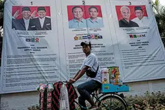 Posters of the presidential and vice-presidential candidates in Jakarta. Though politics swirl, especially with the upcoming general election in Indonesia, comparatively, the risks appear containable and the prospects for Asean are good.