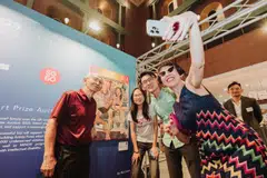 Minister of State for Culture, Community and Youth Baey Yam Keng (in green shirt) with 16-year-old winner Joey Chua and her grandfather James Chua, who appears in her painting. With them is 13-19 advisory committee member Rosalynn Tay.