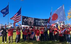 Chairman John Kim (centre in red, beside the man in black) founded the pro-Trump Strong Republic of Korea-US Alliance in defiance to what he believes are communist threats from China, North Korea and Russia – countries that surround South Korea.