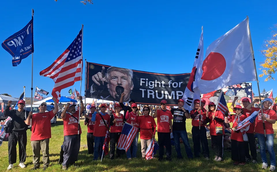 Chairman John Kim (centre in red, beside the man in black) founded the pro-Trump Strong Republic of Korea-US Alliance in defiance to what he believes are communist threats from China, North Korea and Russia – countries that surround South Korea.