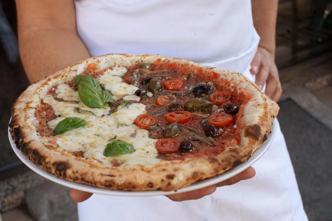The classic Marseille slice is the moitie-moitie (half-half), a tomato-based pie with anchovies on one side and cheese on the other.