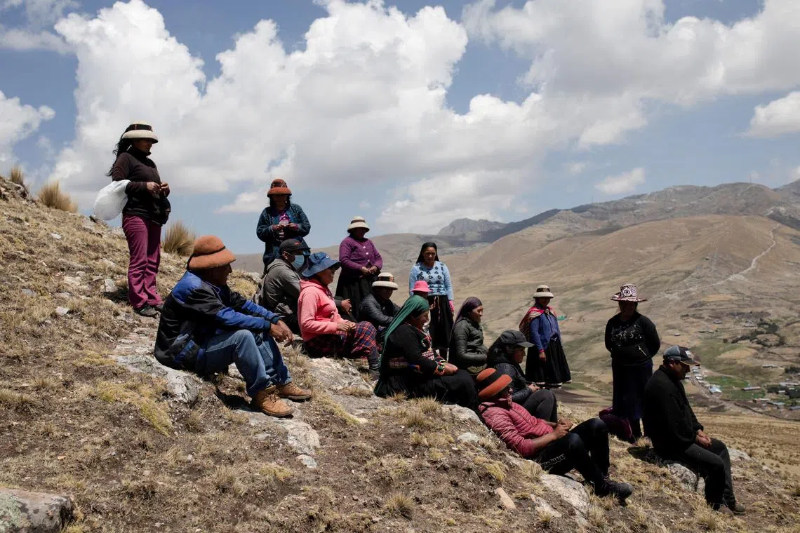 People near a mine operated by MMG Las Bambas, in a region where locals claim mining activity has negatively affected crop yields and killed livestock, outside of Cusco, Peru October 14, 2021. 