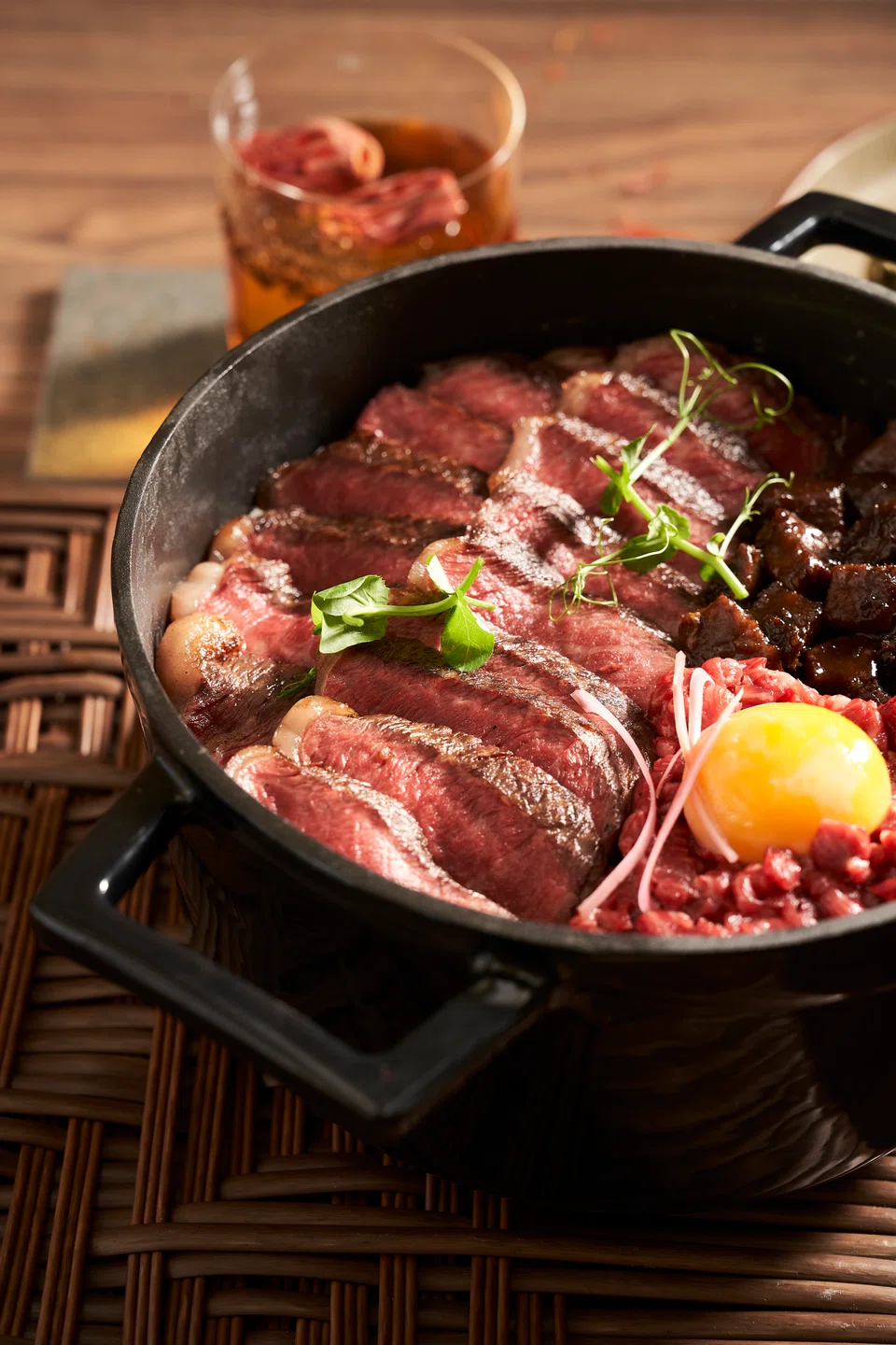 Wagyu steak and tartare served with smoky rice in a clay pot.                              