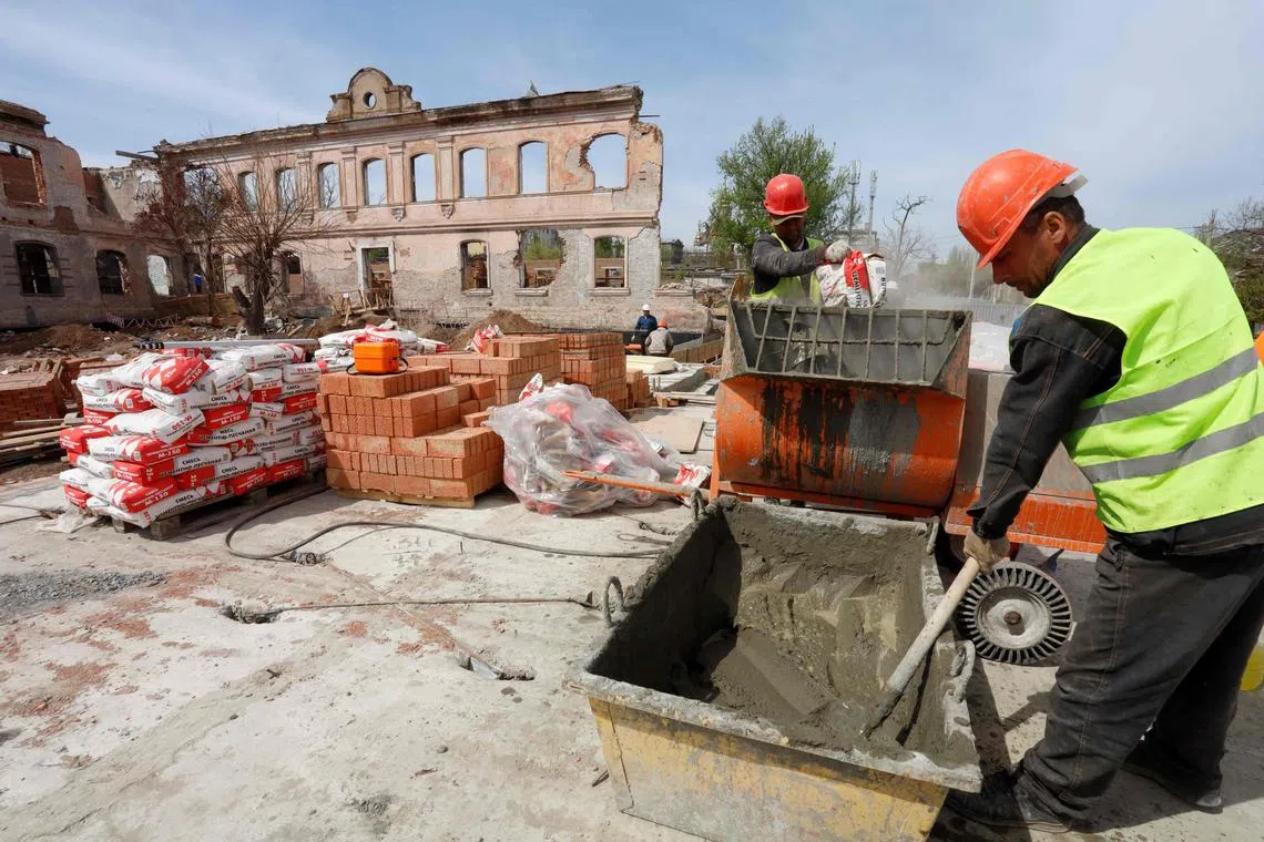 Construction workers rebuild a destroyed district in Mariupol, Ukraine, on April 17, 2024 amid the Russia-Ukraine conflict. 