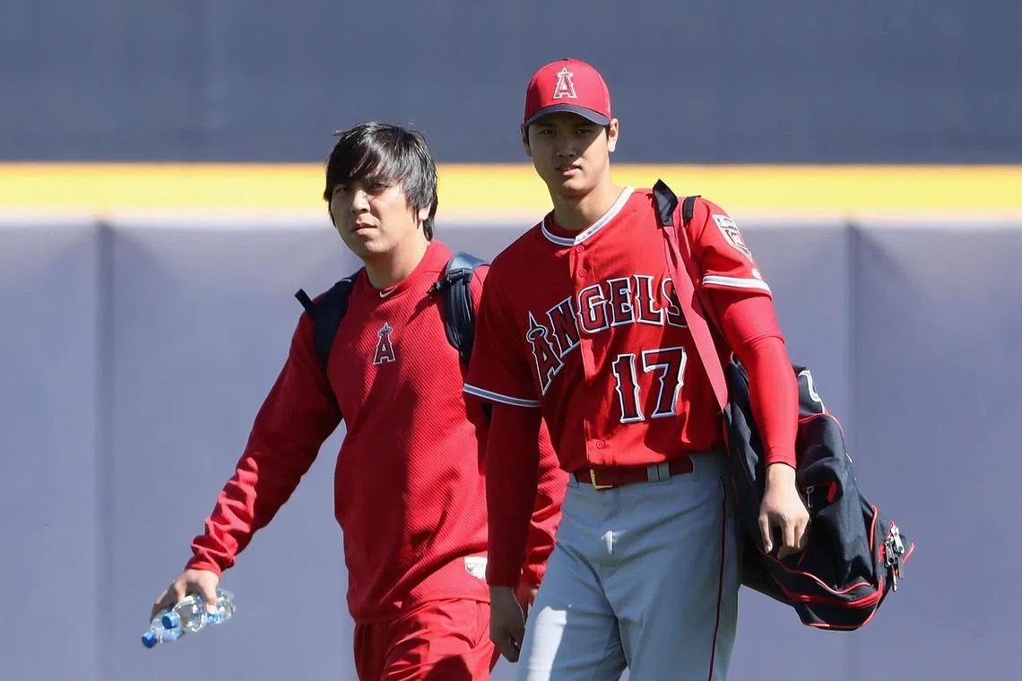 Shohei Ohtani (right) of the Los Angeles Angels arrives with his translator Ippei Mizuhara (left) at Peoria Stadium on Feb 26, 2018 in Peoria, Arizona. Mizuhara was charged with bank fraud on April 11, 2024, for stealing more than US$16 million from Ohtani to pay gambling debts. 