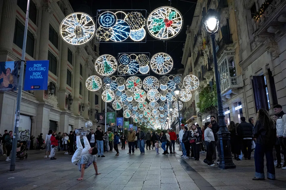 Christmas illuminations along a street in Barcelona. In Spain, annual GDP growth is on track to exceed 3 per cent, driven by a strong labour market and high levels of immigration, which mechanically lifts economic output.