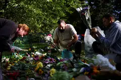 Volunteers remove packaging from floral tributes, following the funeral of Britain's Queen Elizabeth, in Green Park in London, Britain Sep 20, 2022. 