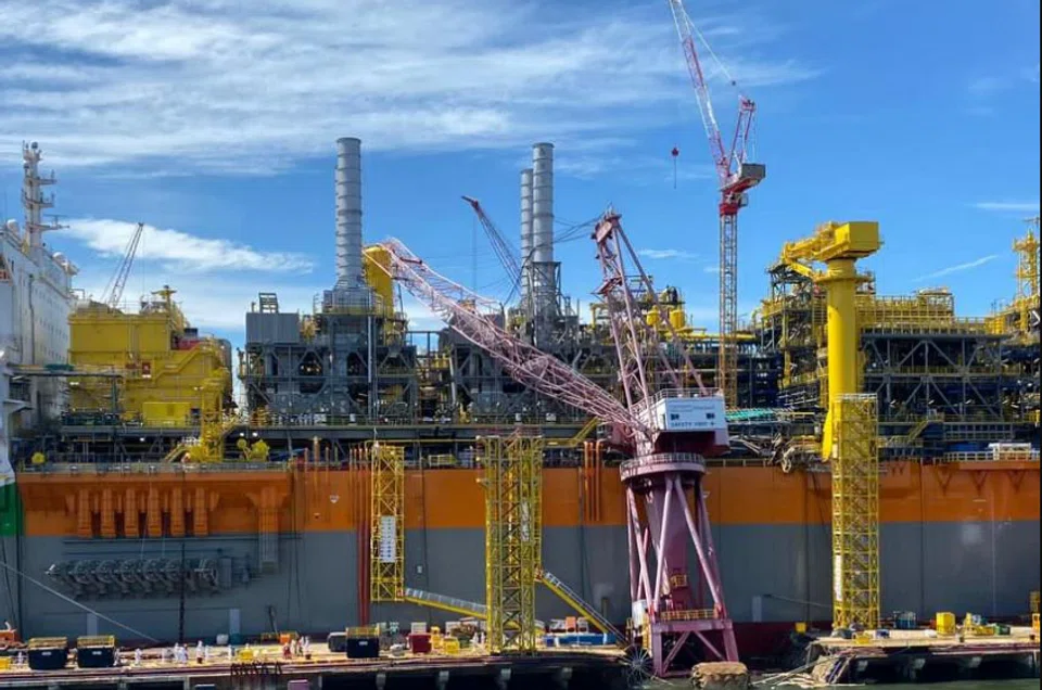 The crane's base appeared to have buckled, causing the rest of the crane to fall towards the berthed ship. 