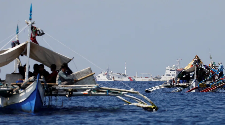 China Coast Guard vessels patrol past Philippine fishing boats at the disputed Scarborough Shoal, April 5, 2017. The sanctions will also target about 170 Chinese entities for what Washington considers illegal fishing in the Pacific, the US officials said.