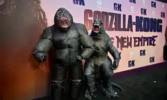 The feature, which sees the enormous gorilla and reptilian giant set their differences aside and team up to save their species.
