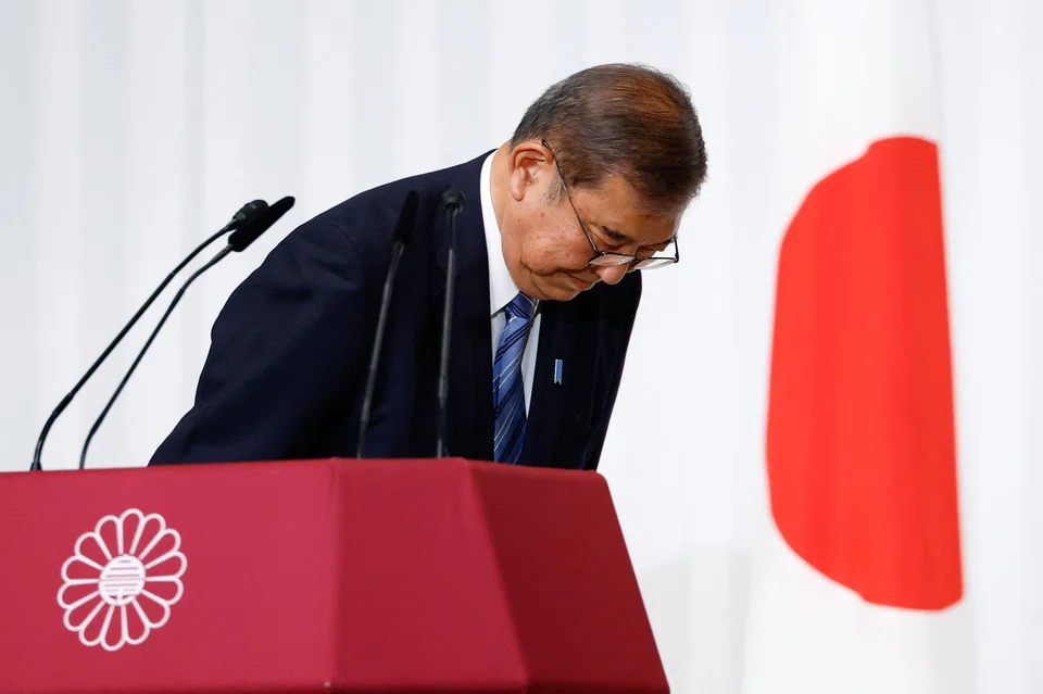Shigeru Ishiba, Japan's Prime Minister and leader of the ruling Liberal Democratic Party (LDP), bows to LDP lawmakers onstage after a press conference at the party's headquarters in Tokyo on Oct 28, 2024. Ishiba said he will stay in office despite his party losing its majority, saying he would not create a "political vacuum".