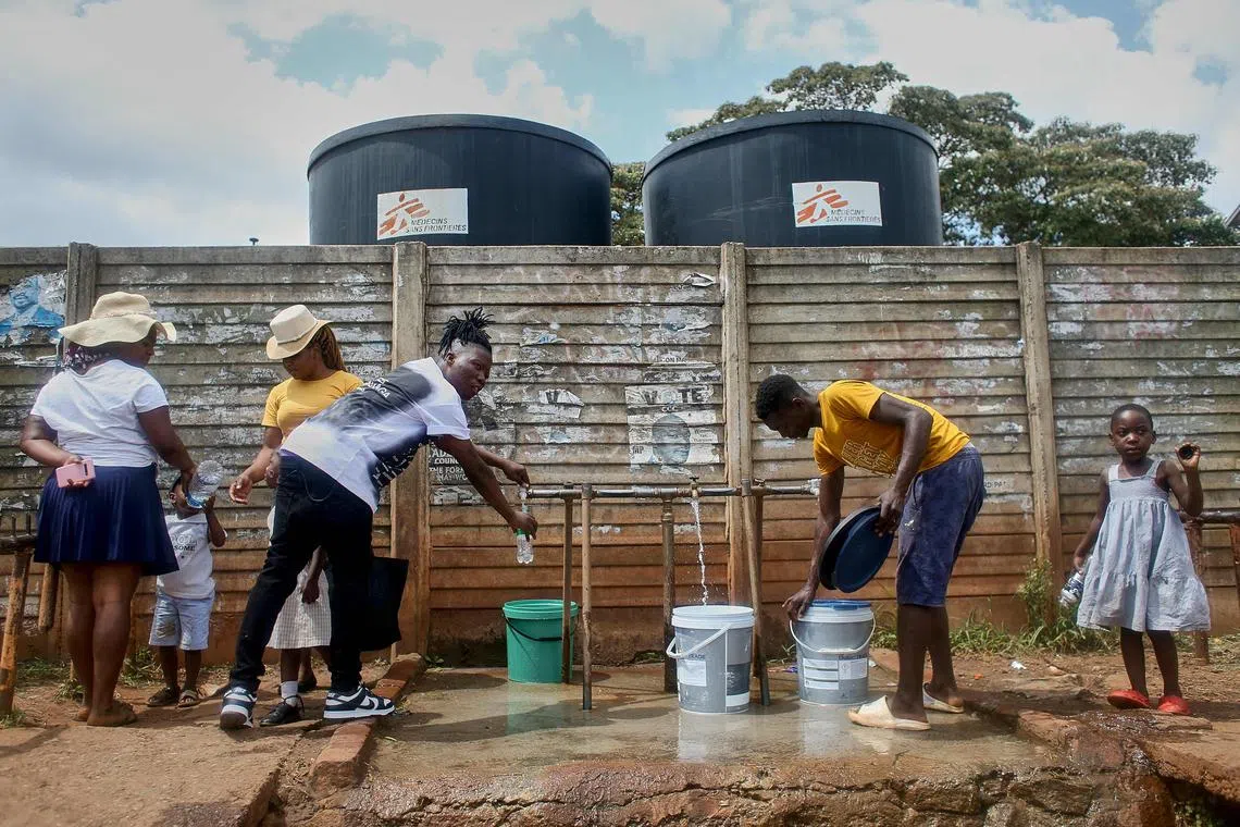 People filling up buckets with safe drinking water in Kuwadzana, Zimbabwe, January 2024. Against the backdrop of a worsening climate crisis, the need to scale collective water action has never been more pressing.