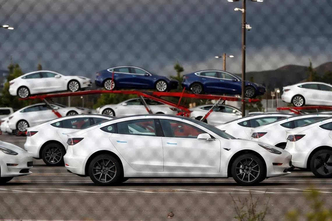 New electric vehicles at Tesla's primary vehicle factory in California. The EV maker said it intends to cut its use of rare earth materials.