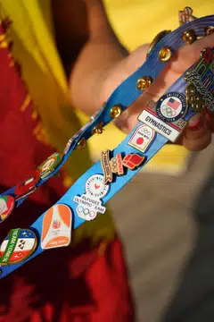 Carolina Marin, a badminton player for Spain, wears her trading pins at the Olympic Village. Pin mania has come roaring back, with athletes chronicling their most prized conquests on social media.