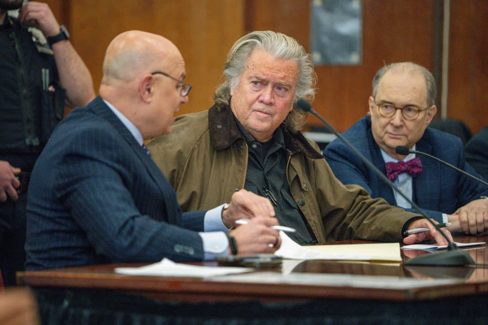 Former advisor to US President Donald Trump Steve Bannon (centre) speaks with his lawyer Arthur Aidala (left) during a pre-trial conference hearing where he entered a guilty plea in his fraud case stemming from a fundraising effort to build a border wall at New York Criminal Court in Manhattan, New York, Feb 11, 2025. 