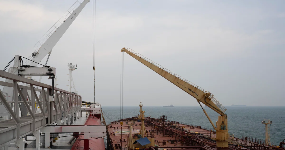 A tanker used as floating storage performs a ship-to-ship transfer with a smaller tanker in Johor, Malaysia, Sep 23, 2026