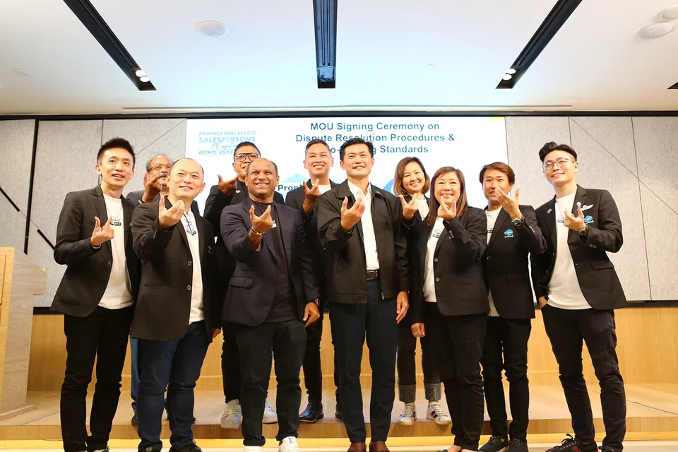 Desmond Tan, Minister of State in the Prime Minister’s Office (centre, front row), says the new guidelines will “help create a better working environment” for PropNex agents.