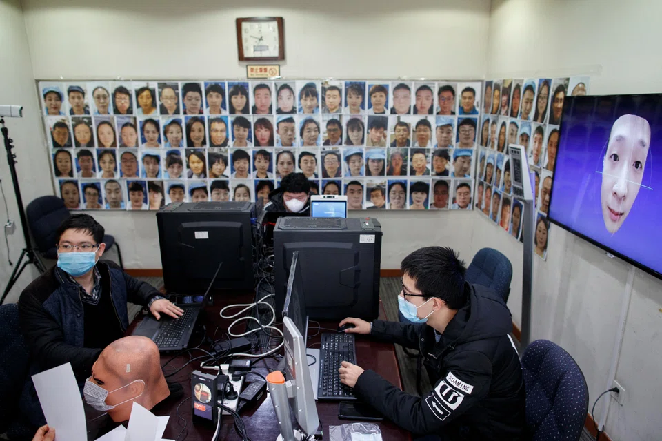 Software engineers work on a facial recognition program that identifies people when they wear a face mask at the development lab of the Chinese electronics manufacturer Hanwang Technology in Beijing, China, March 6, 2020. Hanwang Technology has risen as much as 129 per cent as of Wednesday.