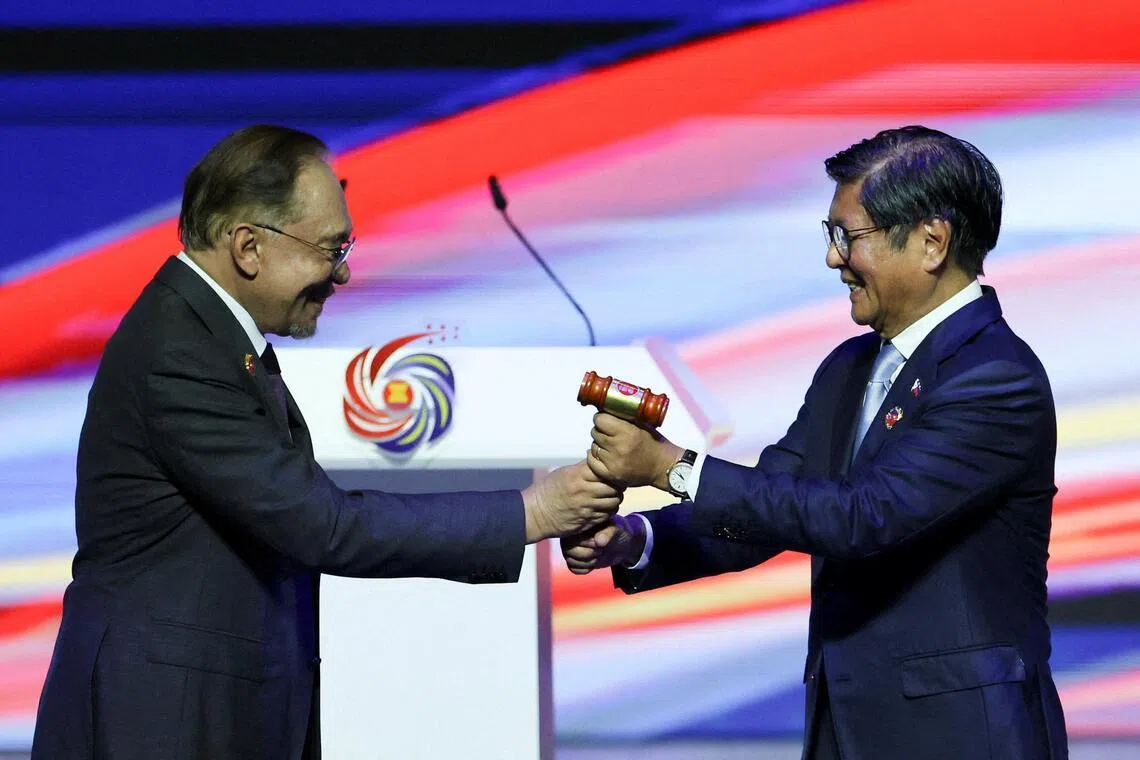Chairman of the Association of Southeast Asian Nations (ASEAN) and Malaysia's Prime Minister Anwar Ibrahim hands over a gavel to the Philippines President Bongbong Marcos, as a symbol of handing over ASEAN chairmanship from Malaysia to the Philippines, during a closing ceremony of the 47th ASEAN Summit and Related Summits in Kuala Lumpur, Malaysia, October 28, 2025. REUTERS/Hasnoor Hussain
     TPX IMAGES OF THE DAY     