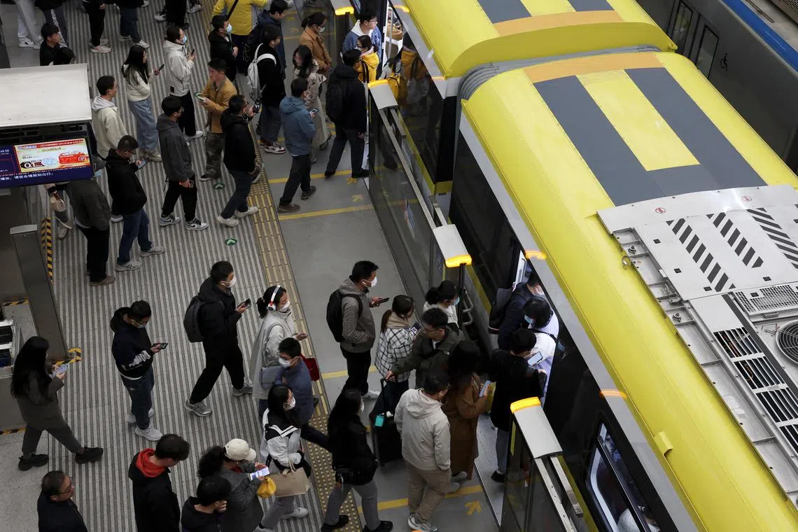 Commuters at a subway station near the Zhongguancun tech hub, during morning rush hour in Beijing.  China has a long average working week – at 46.1 hours in 2024, according to the ILO. 