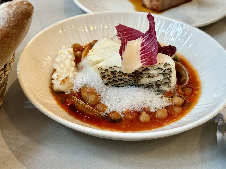 Poached toothfish with squid, clams and chickpeas.