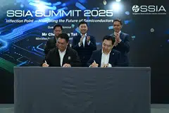 Ang Wee Seng (front right), executive director of the Singapore Semiconductor Industry Association, and Patrick Tay (front left), executive secretary of the United Workers of Electronics & Electrical Industries, sign the memorandum of understanding on skills development. Witnessing the ceremony is Minister for National Development Chee Hong Tat (centre back).