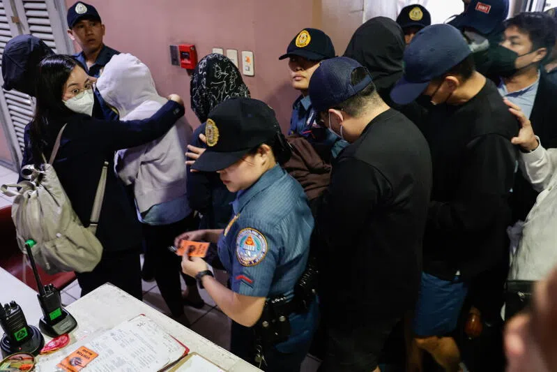 Several of the arrested graft suspects escorted by police to an anti-graft court in Quezon City, Metro Manila.