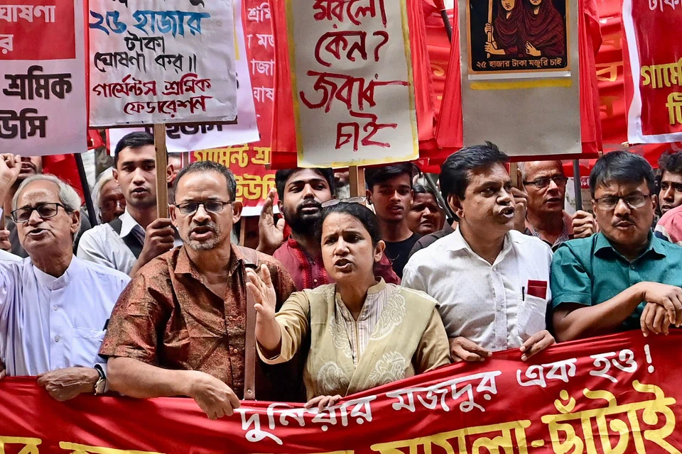 Garment workers and activists taking part in a protest in Dhaka. The unions want a tripling of wages to 23,000 takas.