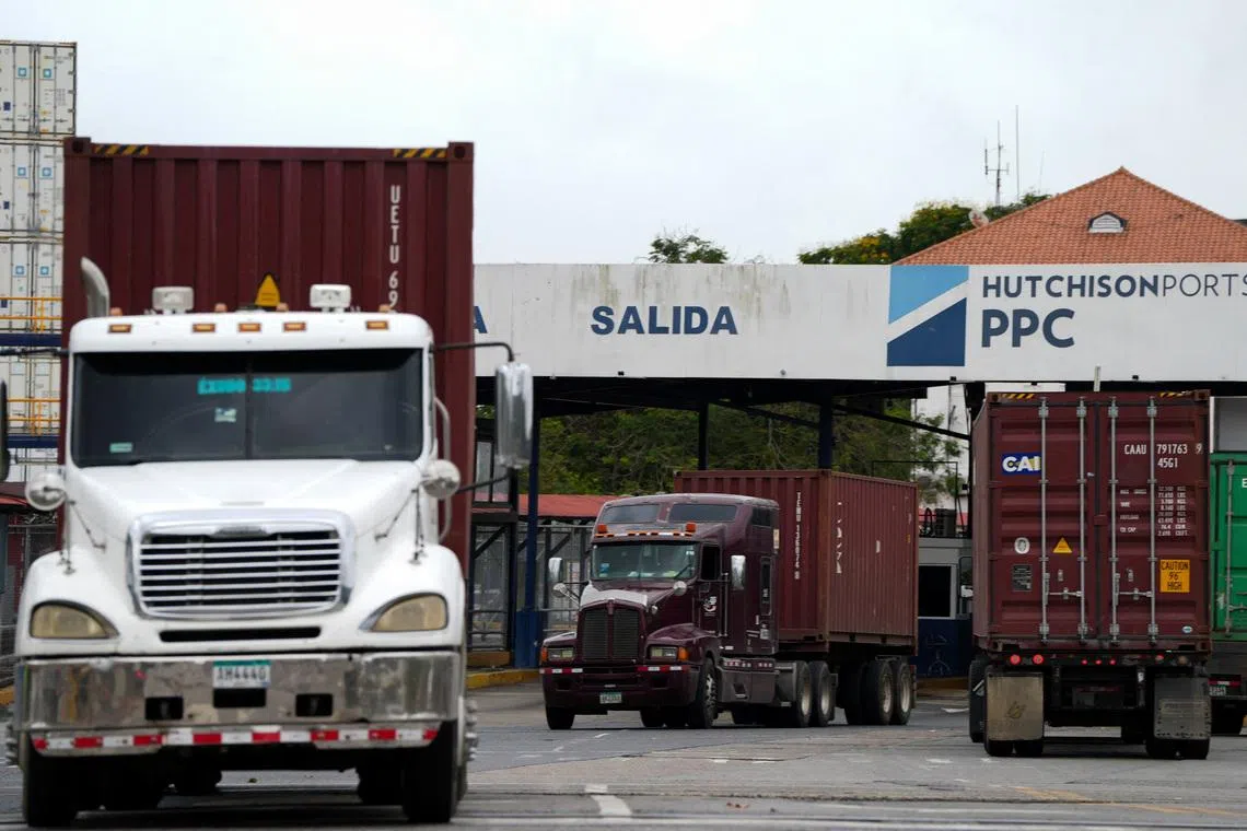 Container trucks leave Panama Ports Company in Panama City on Feb 4. CK Hutchison’s plan to net more than US$19 billion in cash for a group of 43 ports has faced repeated setbacks.