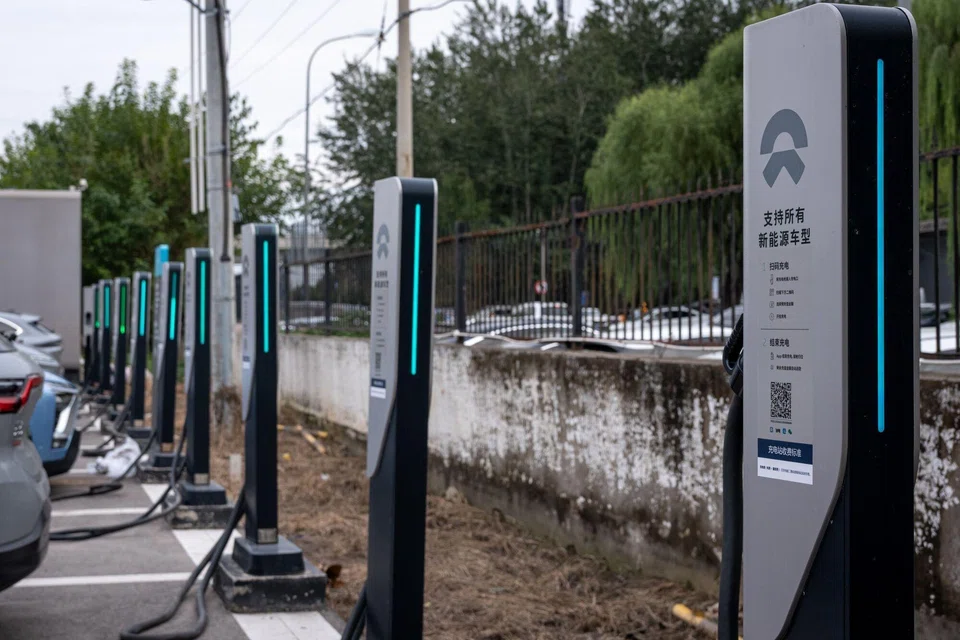 Charging units at a NIO showroom in Beijing, China, Oct 18, 2025. A fifth of the 63.5 million car trips during China's "Golden Week" were in electric or hybrid vehicles, the transport ministry says.