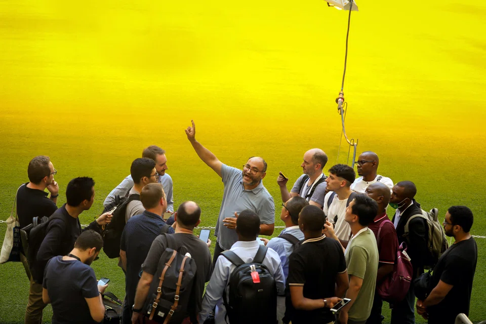 Saud Ghani (centre) explains the cooling system to visiting journalists at Lusail Stadium in Doha, Qatar, on June 13, 2022. Ghani has said he wants people to feel "neutral" – neither warm nor cold.
