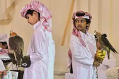Young contestants wait with their falcons during a junior falconry competition in Ras Laffan, some 80 km north of Doha. 
