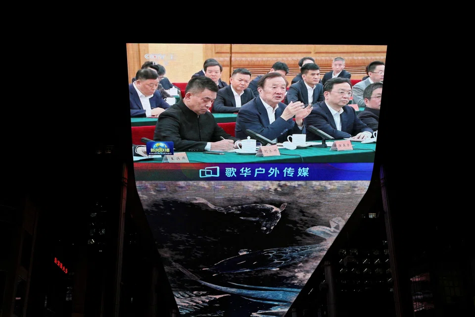 News footage of Huawei founder Ren Zhengfei speaking next to BYD CEO Wang Chuanfu and New Hope's founder and Chairman Liu Yonghao at a symposium on private enterprises with Chinese President Xi Jinping (not pictured) at a shopping complex in Beijing, China, Feb 17, 2025. 