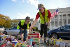 Volunteers arrange groceries during a food drive to replenish food banks ahead of a SNAP lapse at the USDA headquarters in the National Mall, Washington, D.C., Oct 30, 2025. 