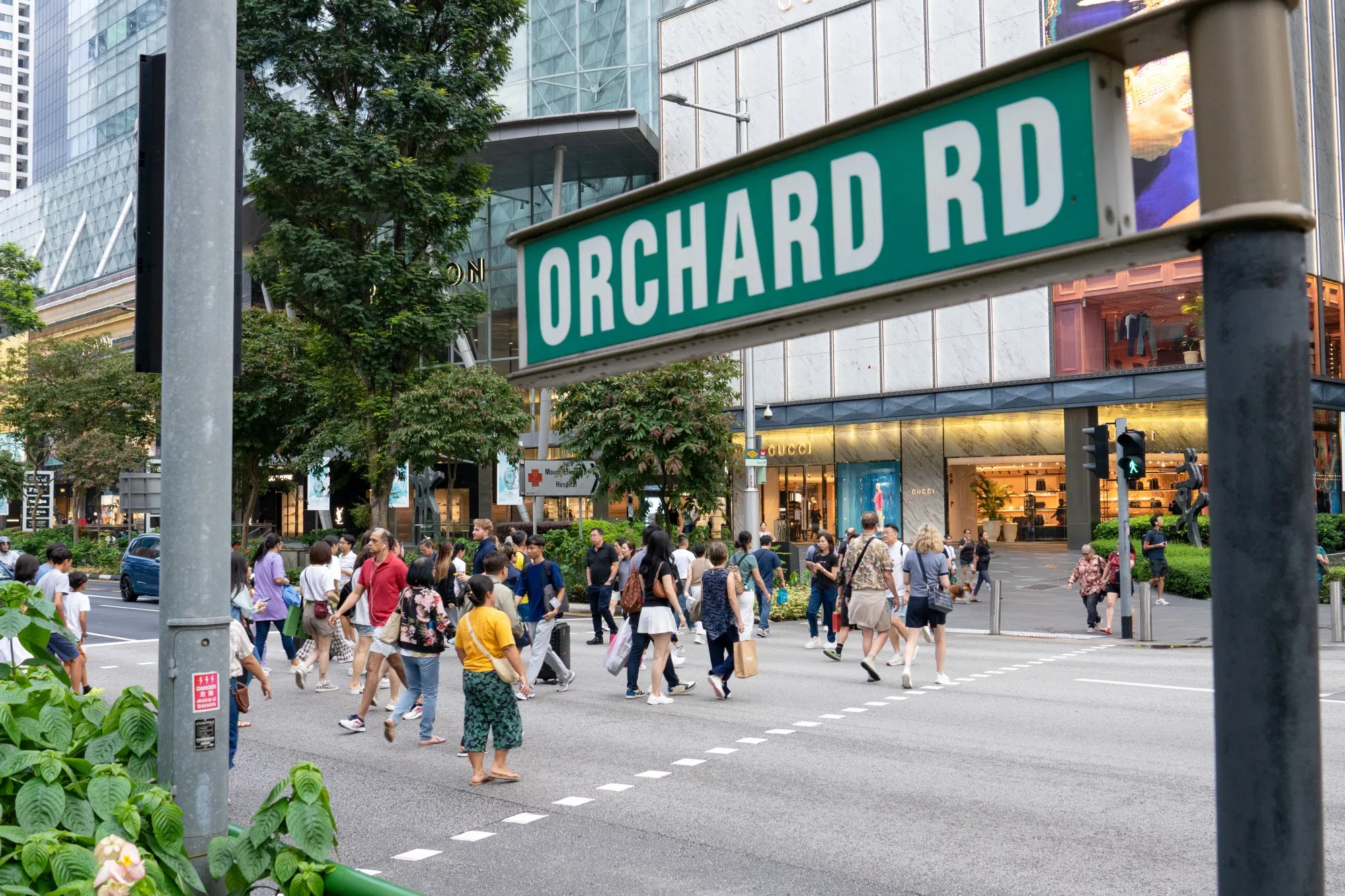 Pedestrians in the Orchard Road area, a global hub for tourism and high-end retail in Singapore. Photographer: Aparna Nori/Bloomberg