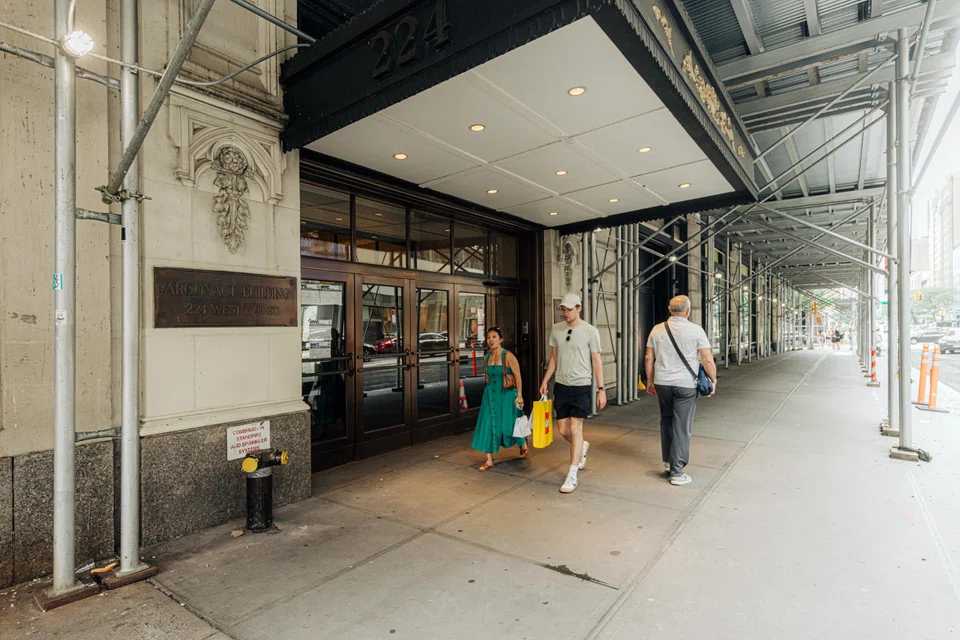 People walk past an entrance to the Argonaut, a 115-year-old office complex in midtown Manhattan, June 22, 2024. The delinquent mortgage on the Argonaut was sold to the family office of the billionaire investor George Soros.  