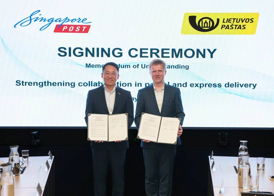 CEO of SingPost international Li Yu (left) and CEO of Lithuania Post Rolandas Zukas at the signing ceremony on May 8.
