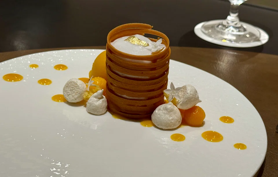 Dessert is a pairing of mango sherbet and coconut mousse.