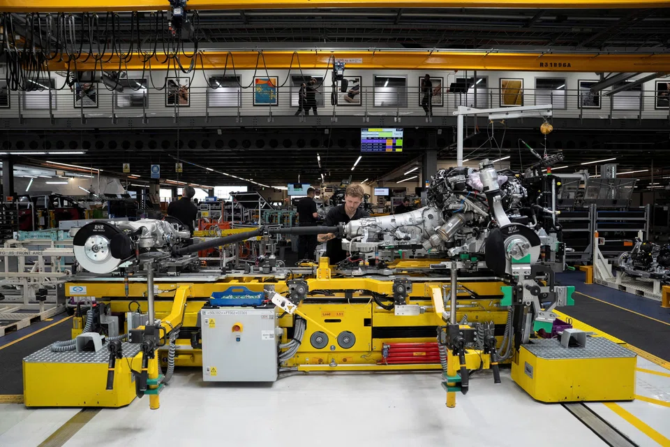 Technicians work on a Rolls-Royce engine prior to it being installed in a car on the production line of the Rolls-Royce Goodwood factory, near Chichester, Britain, May 28, 2025. 